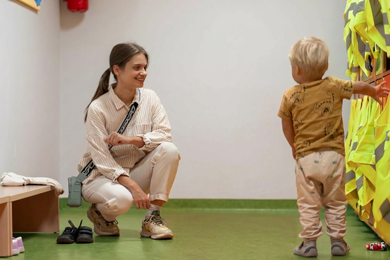 Mutter ist mit ihrem Kind in der Kita-Garderobe
